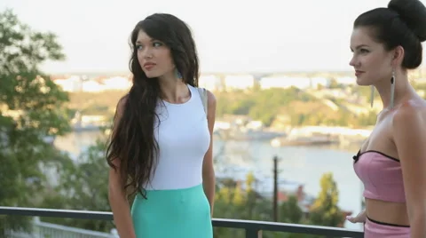 Attractive models in dresses posing on the outdoor terrace Stock Footage 59657569