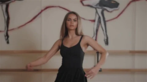 Attractive modern ballet dancer in dance studio, making pa, dance elements, warm Video stock 74270464