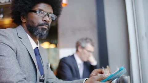 Attractive modern business man using a digital tablet near a window Stock-Footage 87542327