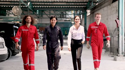 Attractive multicultural mechanics team walking to camera smiling in front .. 스톡 동영상 246067415