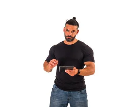 Attractive muscular man using electronic tablet in studio Stock Photos