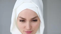 a beautiful woman in a forest, wearing hijab, looking_at camera