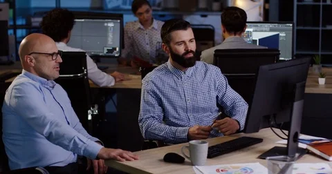 Attractive office worker discussing with his boss startup project while sitting Stock Footage 82447381