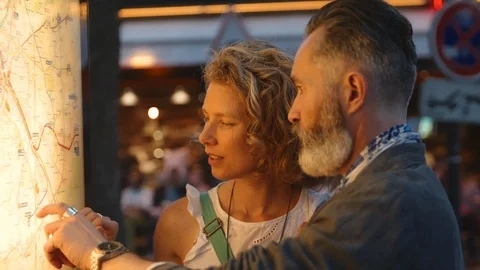 An attractive older couple looking at map and deciding on their next adventure Stock Footage 120186557