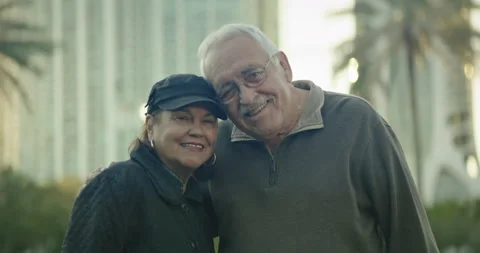 Attractive older couple at park looking at camera and smiling Stock Footage 234531435