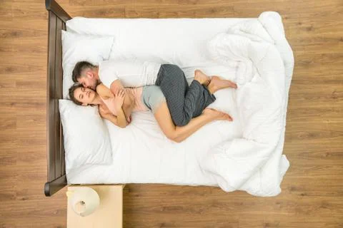 The attractive pair sleeping on the bed. View from above Fotos Stock