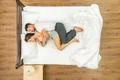 The attractive pair sleeping on the bed. View from above Photo