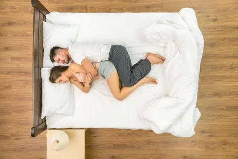 The attractive pair sleeping on the bed. View from above Fotos Stock