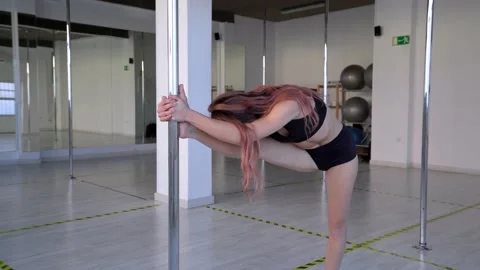 Attractive pole dancer getting ready for a class doing stretching. Flexible woma Video stock 146601771