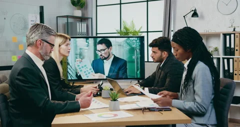 Attractive positive experienced mixed race businesspeople have video conference Stock Footage 161016368