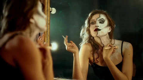 Attractive professional actress doing makeup and smoking in dressing room. Split Stock Footage 295200183