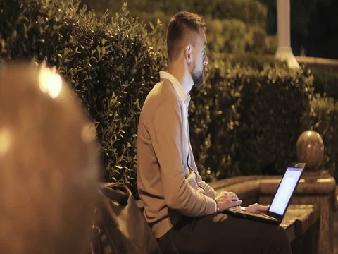 Attractive professional man with a beard working on a laptop computer is alone w Stock Footage 79800994