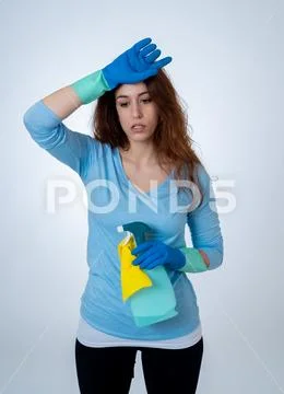 Attractive red haired woman bored and restless of cleaning and housekeeping Stock Photos