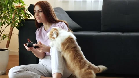 Attractive red head Long-haired girl with freckles playing video games near dark Stock Footage 150100139