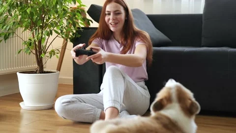 Attractive red head Long-haired girl with freckles playing video games near dark Stock Footage 150660186