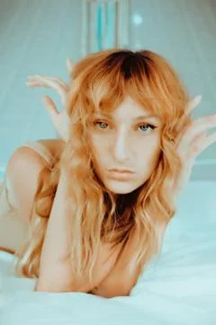 Attractive redhead model on bed Stock Photos