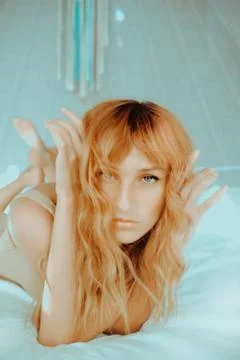 Attractive redhead model on bed Stock Photos