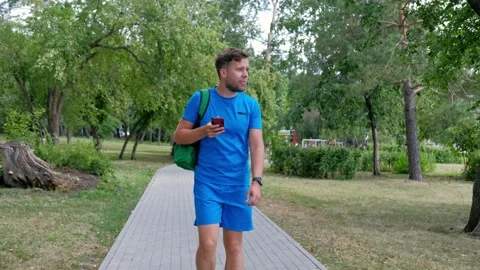Attractive runner in blue sportswear using smartphone checking fitness results. Stock Footage 140957338