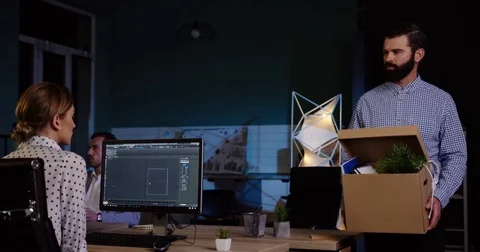 Attractive sad office worker with a beard carrying a box with his stuff walking Stock Footage 82447190
