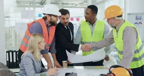 Attractive satisfied experienced bearded customer handshaking with main man of Stock Footage 145612612