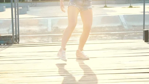 Attractive sensual girl dancing modern passionate dance onthe glare. Slowly Stock Footage