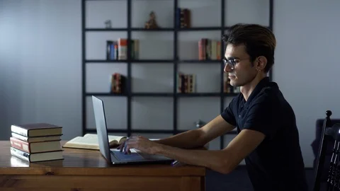 Attractive Serious Student Studying with Computer, Typing Notes, Looking at the Stock Footage 93301335