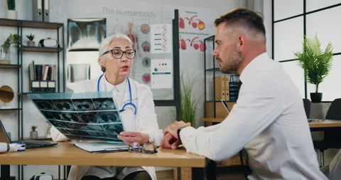 Attractive serious stylish bearded man visiting his experienced caring respected Stock Footage 160819729