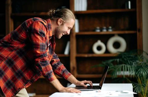 Attractive smart caucasian freelancer, using laptop. American stylish guy Stock Photos