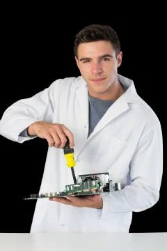 Attractive smiling computer engineer repairing hardware at night Stock Photos