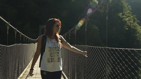 Attractive Smiling happy Explorer redhead girl walking, hiking, crossing Stock-Footage 119346189