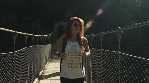 Attractive Smiling happy Explorer redhead girl walking, hiking, crossing Stock Footage 119346266