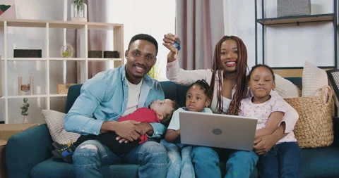 Attractive smiling happy modern young african american family with kids sitting Stock Footage 150660375