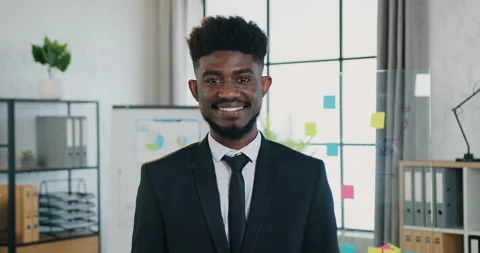 Attractive smiling skilled successful young bearded black-skinned businessman in Stock Footage 159715146