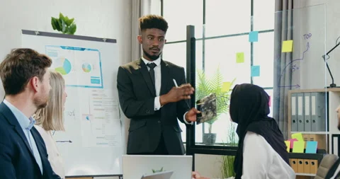 Attractive smiling successful black-skinned male leader holding business Stock Footage 159706505