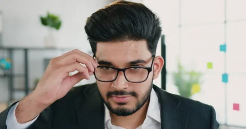Attractive smiling successful young bearded office manager taking off his Stock Footage 159720258