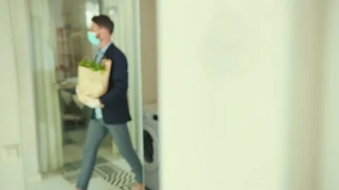 Attractive stylish man coming back home after food shopping entering house Stock Footage 132541450