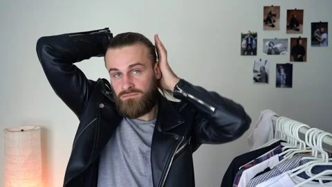 Attractive stylish man in leather jacket is wearing a suit Video stock 147899949