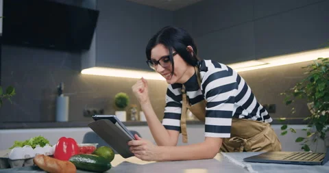Attractive surprised dark-haired young woman showing emotional reaction on good Stock Footage 148871280