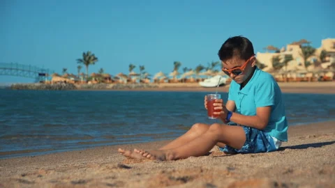 https://images.pond5.com/attractive-teen-boy-sunglasses-drinking-footage-140501350_iconl.jpeg