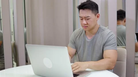 Attractive tired bored guy programmer digital tech manager sitting at desk wo Stock-Footage 169730003