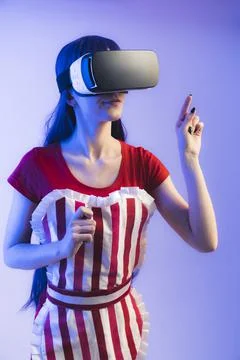 Attractive Waitress using VR headset goggles and virtual interface to check the Stock Photos