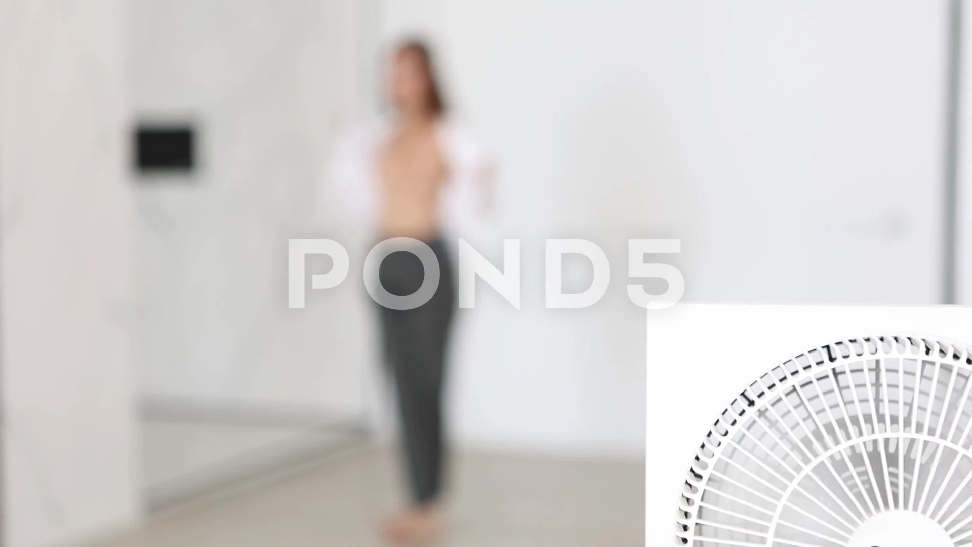 Attractive white woman undressing in her room, selective focus.