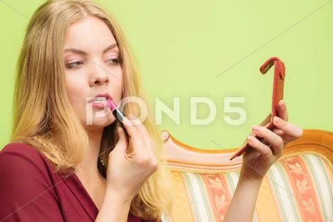 Attractive Woman Applying Lipstick. Make Up.