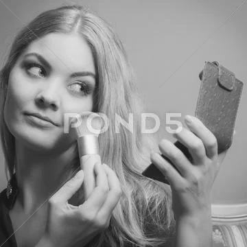 Attractive Woman Applying Make Up With Brush.