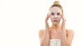 The attractive woman with a clean mask touching the face on the white background 4k or 4k+ Resolution