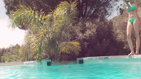 Attractive woman diving in the pool Stock Footage 58562647