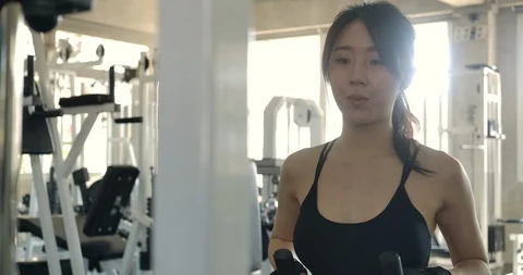 Attractive woman doing exercise at crossover machine in gym. Video stock 107019012