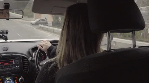 Attractive woman driving car whilst talking on hands free in slow motion Stock Footage