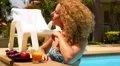 Attractive Woman Enjoying Juice and Sunbathing in Swimming Pool in Resort. HD Footage