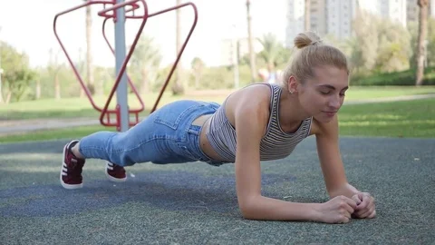 Attractive woman on exercise doing situps in park, plank workout. Stock Footage 81383121